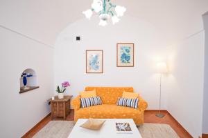 a living room with a couch and a table at Casa Chiesa Nuova in Positano