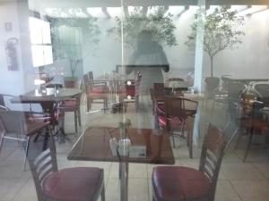 a dining room filled with tables and chairs at Hotel Saint Paul 01 Flat in Manaus