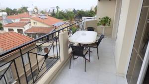balcone con tavolo e sedie bianchi di Kimonos Guesthouse a Larnaka