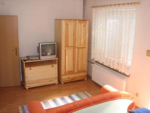 a living room with a tv on a wooden dresser at Privat u Starona in Liptovský Ján