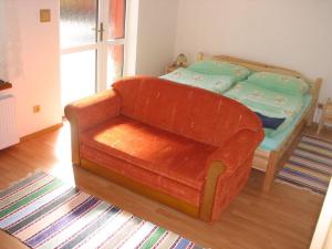 a living room with a couch and a bed at Privat u Starona in Liptovský Ján