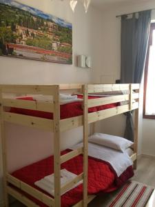 two bunk beds in a room with a painting on the wall at Roman Theater in Verona
