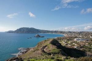 an island in the ocean next to a body of water at Panorama Studios in Kefalos