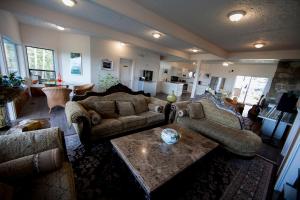 a living room with couches and a coffee table at Shangri-La Oceanfront vacation home in Bedwell Harbour