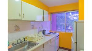 a kitchen with a sink and a stove at Sundreamer Suite @ Turtle Towers in Ocho Rios