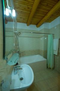 a bathroom with a sink and a bath tub at Bibi-Khanym Hotel in Bukhara +32 photos