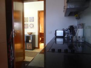 a kitchen with a stove and a counter top at Alvor Ria Apartment in Alvor