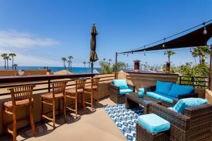 a patio with chairs and a bar with the beach at Rooftop Deck Spectacular Ocean View M-A in Oceanside
