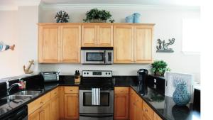 a kitchen with a stove and a microwave at Anglers Reef Paradise in Islamorada