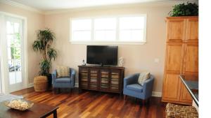 a living room with two blue chairs and a television at Anglers Reef Paradise in Islamorada