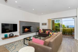 a living room with a couch and a fireplace at Ocean View Steps to Beach M-C in Oceanside