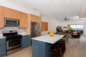 a kitchen with blue cabinets and a counter top at Ocean View Steps to Beach M-C in Oceanside