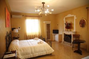 a bedroom with a bed and a fireplace at À La Maison De Gabry in Vibo Valentia Marina