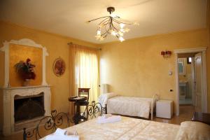 a bedroom with two beds and a chandelier at À La Maison De Gabry in Vibo Valentia Marina