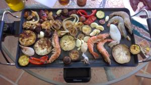 a tray filled with different types of vegetables on a table at Garden Apartment Quinta do Morgado in Tavira