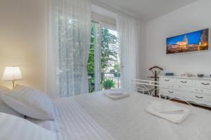 Postel nebo postele na pokoji v ubytování Adriatic Apartments