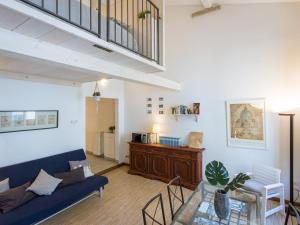 a living room with a blue couch and a table at San Lorenzo Bright Loft in Florence