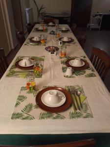 a long table with plates and utensils on it at La Camelia B&B in Velletri