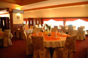 a banquet room with white tables and chairs at Hotel Zajazd Piastowski in Kazimierz Dolny +36 photos