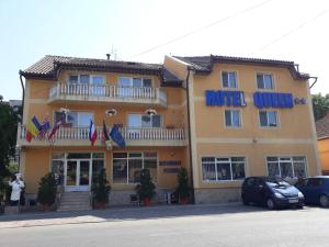 a hotel with cars parked in front of it at Vila Queen in Arad