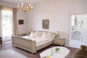 a bedroom with a bed and a chandelier at Alte Villa Schlossblick in Bad Pyrmont