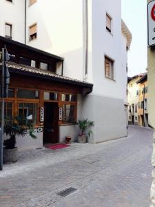 a white building with a door and a courtyard at Hotel Doria in Nago-Torbole