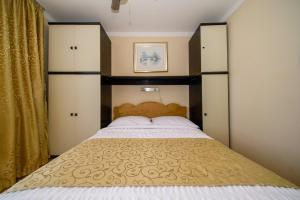 a bedroom with a large bed with a wooden headboard at Porto Romantico 2 in Sveti Juraj