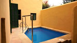 a swimming pool in the side of a house at Villa Major 88 - House in Lluchmayor, Mallorca in Llucmajor