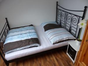 a bed with two pillows on it in a room at Schöne komplette Ferienwohnung in Wesel in Wesel