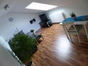 a living room with a wooden floor and a table at Schöne komplette Ferienwohnung in Wesel in Wesel +11 photos