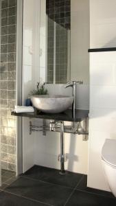 a bathroom with a sink and a mirror at Södra Hotellet in Norrköping +64 photos