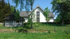 a white house in a field with trees at Villa Loch Nr.5 in Litschau