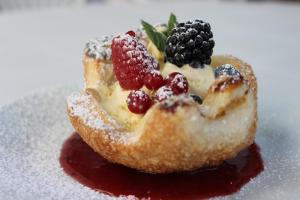 a pastry with fruit on top of it on a plate at Hotel Astra in Cattolica +23 photos
