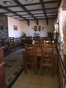 a dining room with wooden tables and chairs at Khorol-1 Motel in Khorol