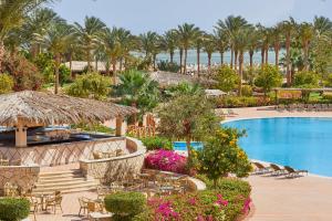 an image of a resort with a swimming pool and palm trees at JAZ Mirabel Resort in Sharm El Sheikh