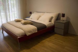 a bedroom with a large bed with white pillows at Skender's Apartment in Interlaken