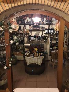 a room with a counter with bottles of wine at Locanda-Trattoria Al Rio in Cinto Euganeo