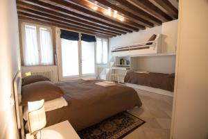 a bedroom with two beds and a large window at La Coccola in Venice