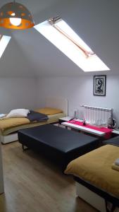 a bedroom with two beds and a skylight at Guesthouse Jelic in Teslić