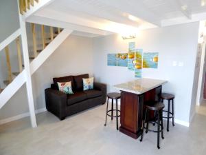 a living room with a couch and a table at Beach Two Bedroom Loft Suite E29 in Ocho Rios
