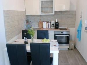 a kitchen with a counter and a table with fruit on it at Villa Santa Barbara in Vrsi