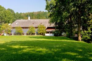 a large house with a large green field in front of it at Hotel Zajazd Piastowski in Kazimierz Dolny