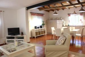 a living room with a table and a dining room at La Villa in Mogán