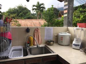 a kitchen counter with a sink and a mixer at Villa Diantie in Bogor
