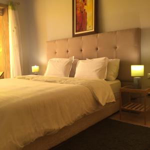 een slaapkamer met een groot bed met witte lakens en kussens bij prestigia in Marrakesh
