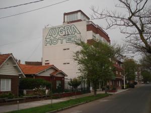 a hotel with a sign on the side of a building at Lugra Hotel in Miramar