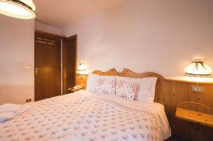 Postel nebo postele na pokoji v ubytování Albergo Vezzana
