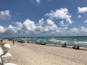 a group of people on a beach with umbrellas at Ocean Reserve Piso 4 STR264 in Miami Beach