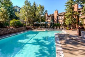 a swimming pool in front of a building at The Lodge at Steamboat by Vacasa in Steamboat Springs