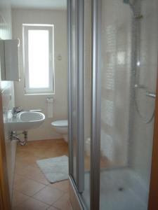 a bathroom with a shower and a sink at Ferienwohnung Michael Meißner ruhig, gemütlich und kinderfreundlich in Crottendorf +14 photos